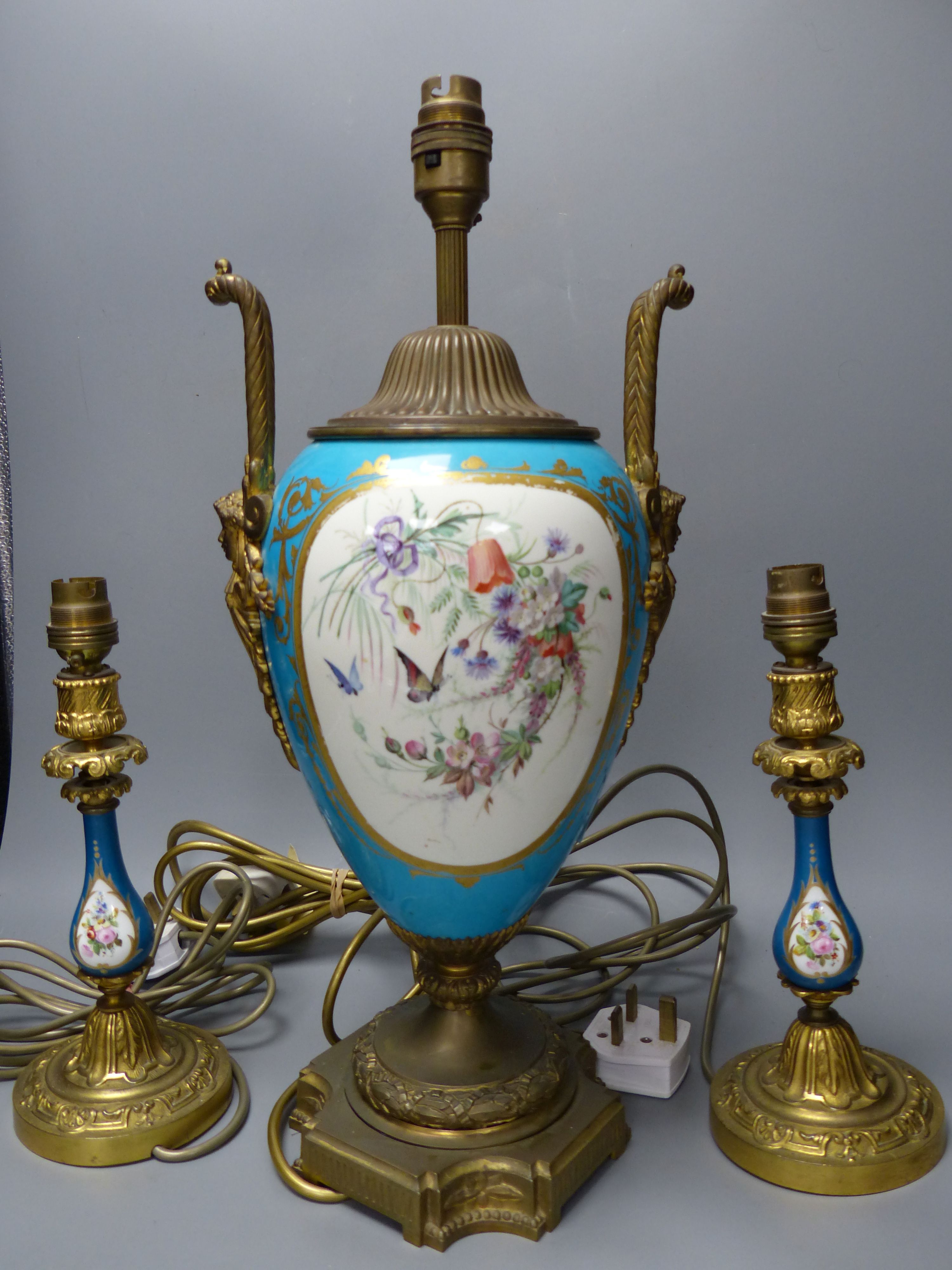 A pair of 19th century Sevres style porcelain and ormolu mounted lamps and a similar larger lamp